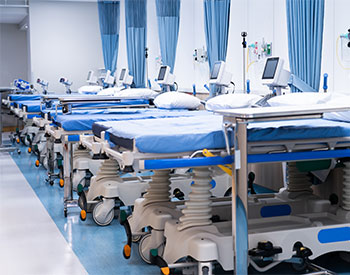 Empty modern hospital bed in fully equipped room Medical equipment.