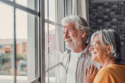 Healthy Aging Couple smiling looking out window